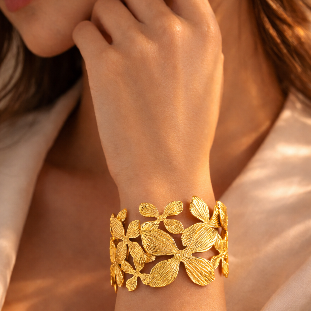 Model wearing gold flowral cuff by Auryn Jewells